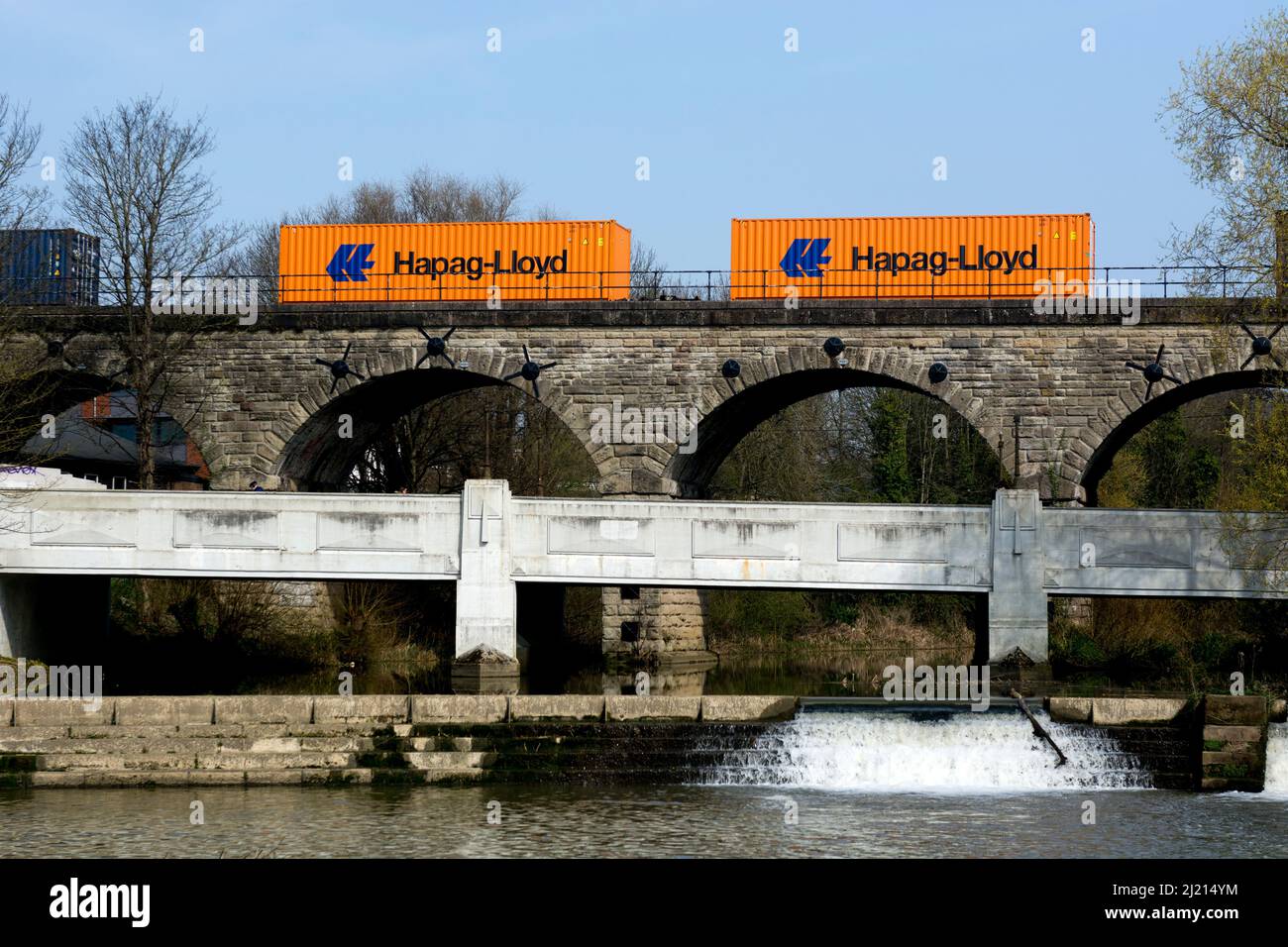 Hapag-Lloyd shipping containers on a freightliner train crossing Price`s Drive viaduct, Leamington Spa, UK Stock Photo
